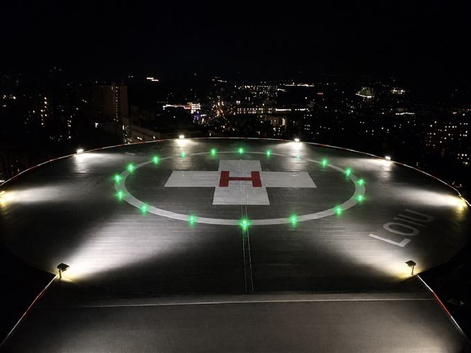 Elevated heliport with perimeter lighting at night